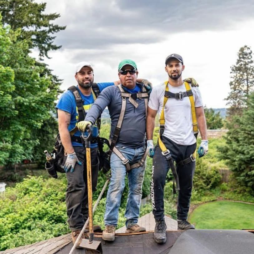 The BSR family crew standing on a roof in Seattle