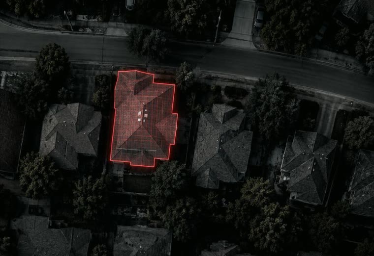 Aerial view of a neighborhood with one roof outlined and measured