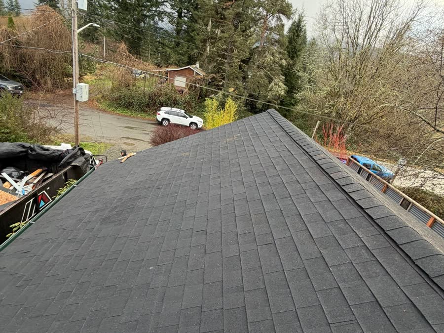 New charcoal shingle roof after replacement
