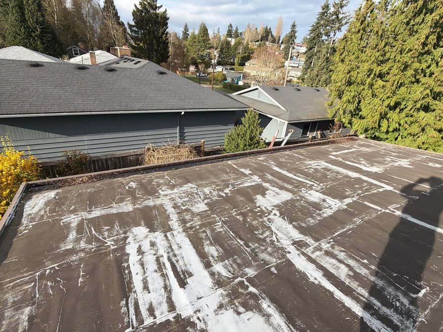 Patched worn flat roof before replacement