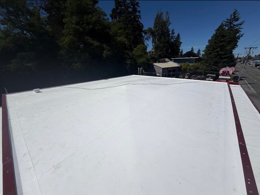 New white TPO commercial flat roof after replacement