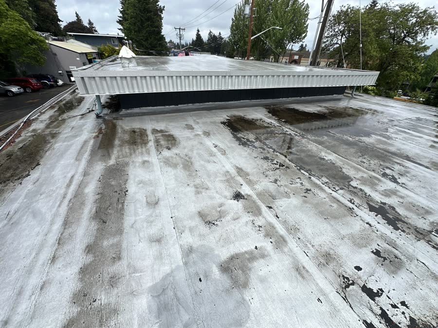 Dirty aging commercial flat roof before replacement
